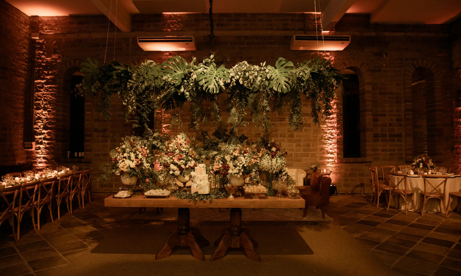 Wide reception room with dance floor and hanging florals