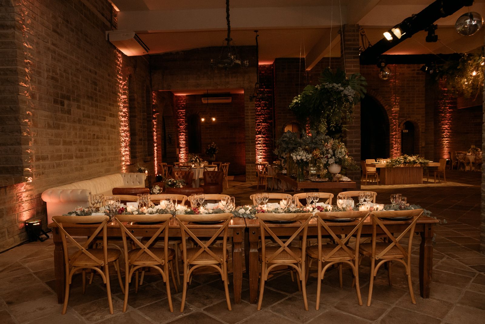 Long farm table styled with linen runner and florals