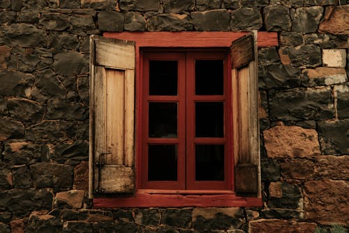 Stone House Wall with Wooden Windows and Shutters