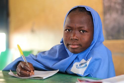 Schoolgirl Writing on Paper