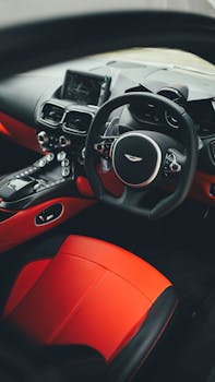 Detailed view of a luxury car interior with red leather seats and modern dashboard.