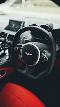 Close-up shot of a premium car's steering wheel and dashboard, showcasing luxury and design.