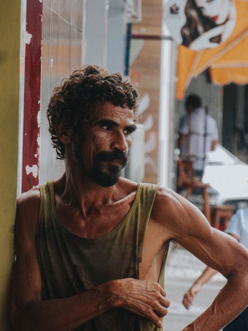 Free Portrait of a bearded man in a tank top leaning against a wall, in urban Eunapolis, Brazil. Stock Photo