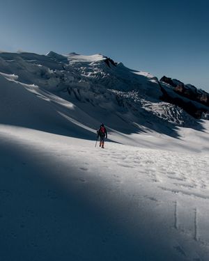 Hiker climbing a snowy slope — photo by Marcio Arias on Pexels