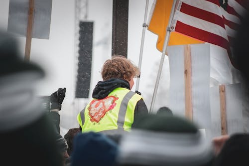 Man Wearing Reflective Vest on a Parade 
