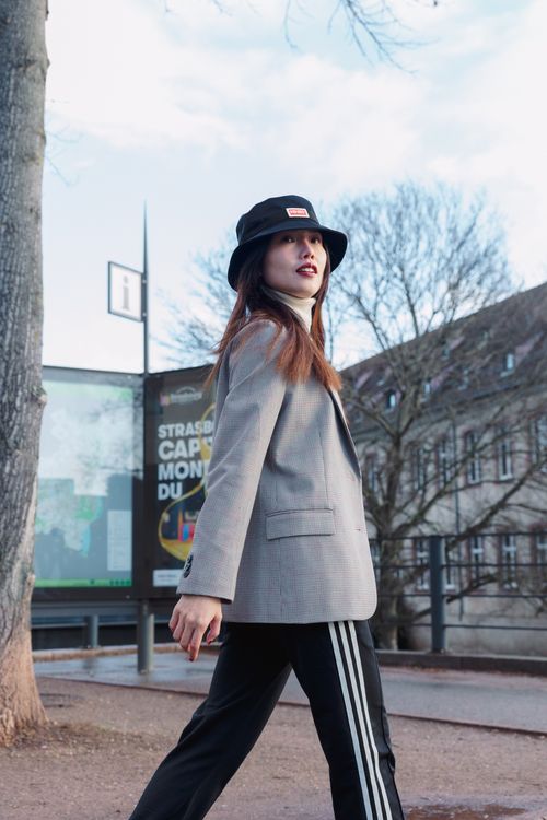 Free Woman in modern attire walking on city street, exuding urban fashion vibes. Stock Photo