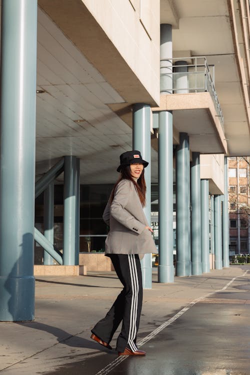 Female Model Wearing a Hat and a Gray Coat