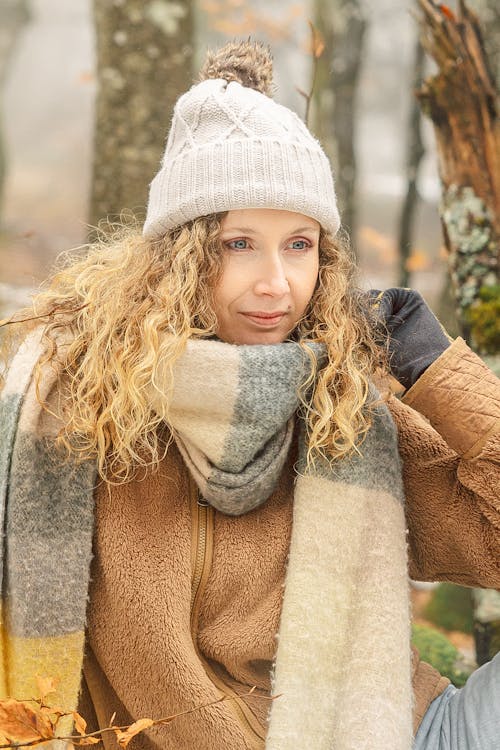 Portrait of a Pretty Blonde Wearing a Knit Hat and a Fluffy Scarf