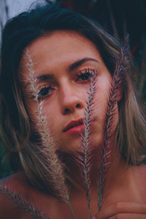 Three Grasses Near Woman's Face