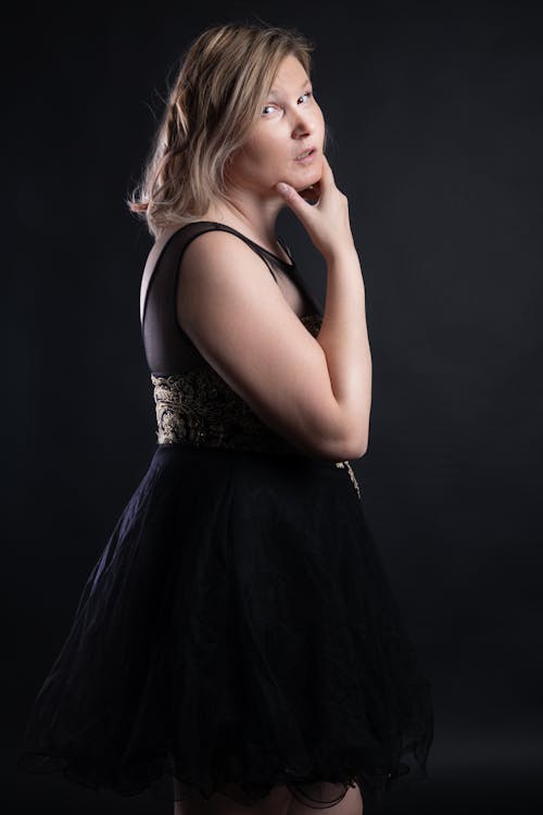 Blonde Woman Posing in Dress in a Studio 