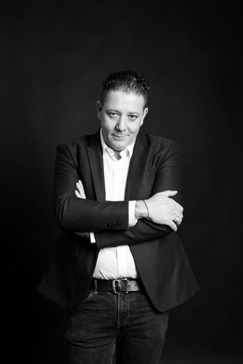 Free Stylish black and white portrait of a man posing confidently in a studio. Stock Photo