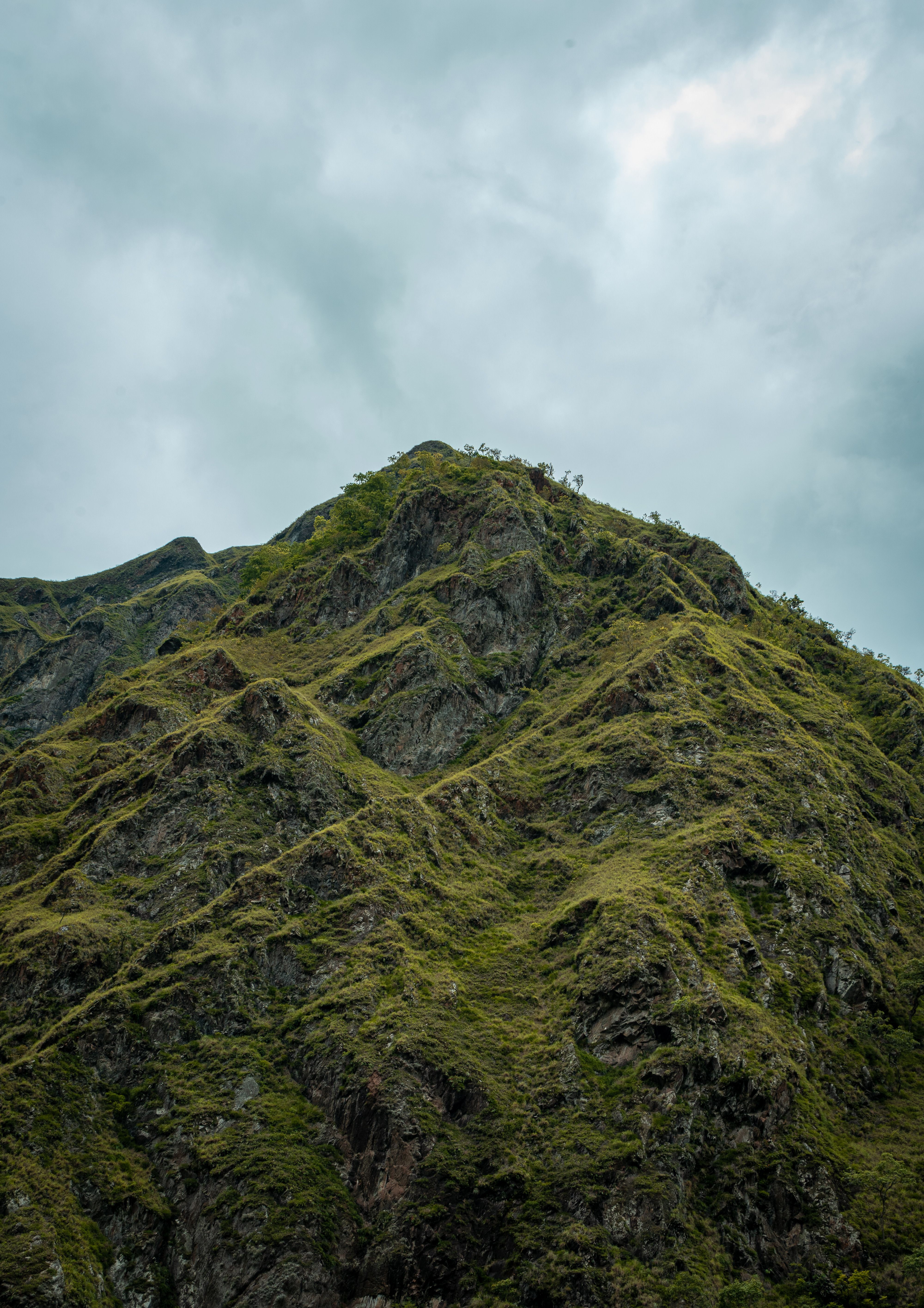 View of a Rocky Mountain under a Cloudy Sky · Free Stock Photo