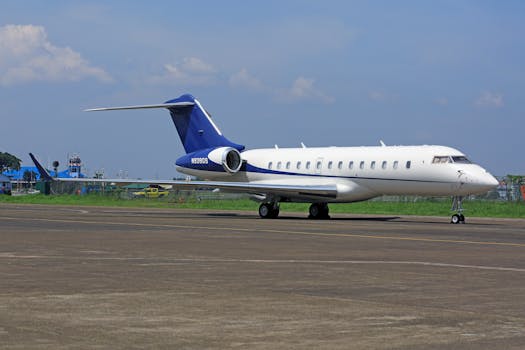 A sleek private jet parked on the airport tarmac under a clear blue sky, conveying luxury and travel.