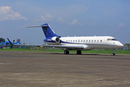 Free A sleek private jet parked on the airport tarmac under a clear blue sky, conveying luxury and travel. Stock Photo