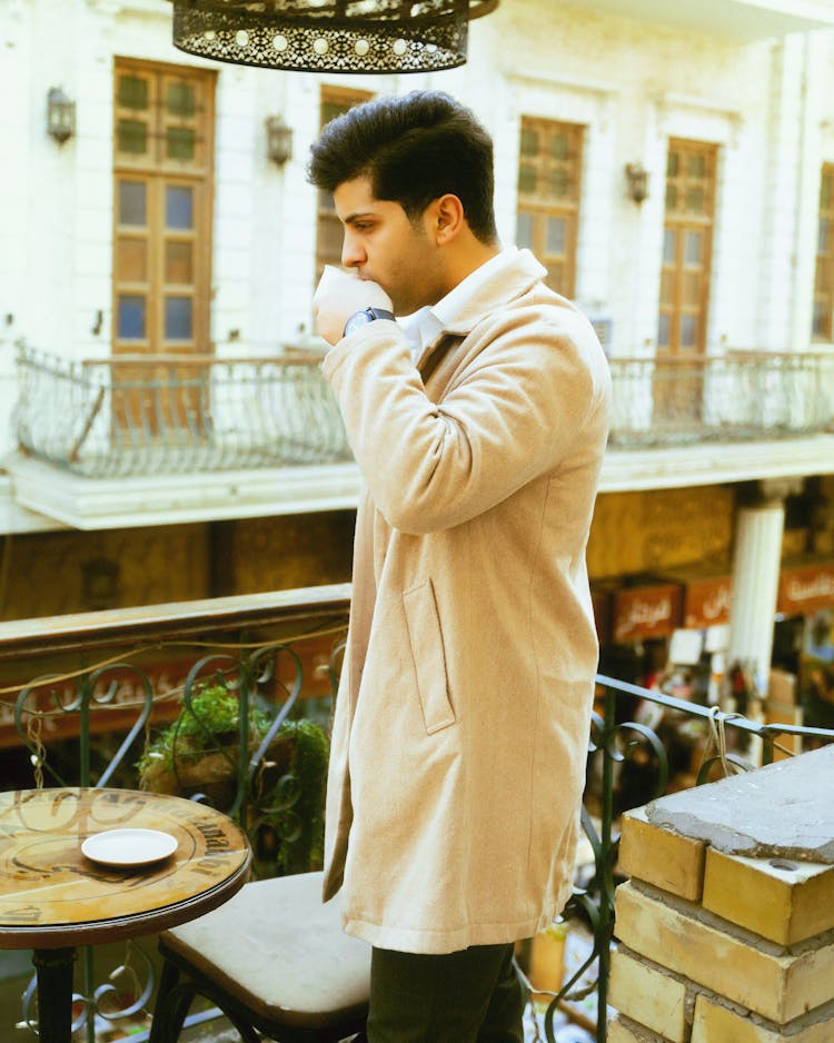 Man In Coat Drinking Coffee