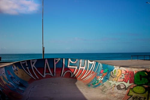 View of a Skatepark with Graffiti on a Seashore 