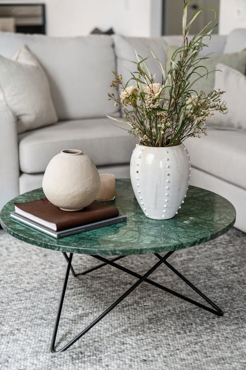 Flowers, Vases and Books Standing on a Coffee Table in a Living Room 