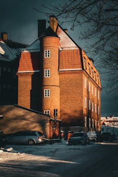 Historic brick apartment building in snowy Jönköping, Sweden during wintertime.