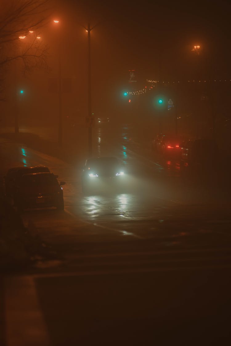 Cars On Street Under Fog At Night