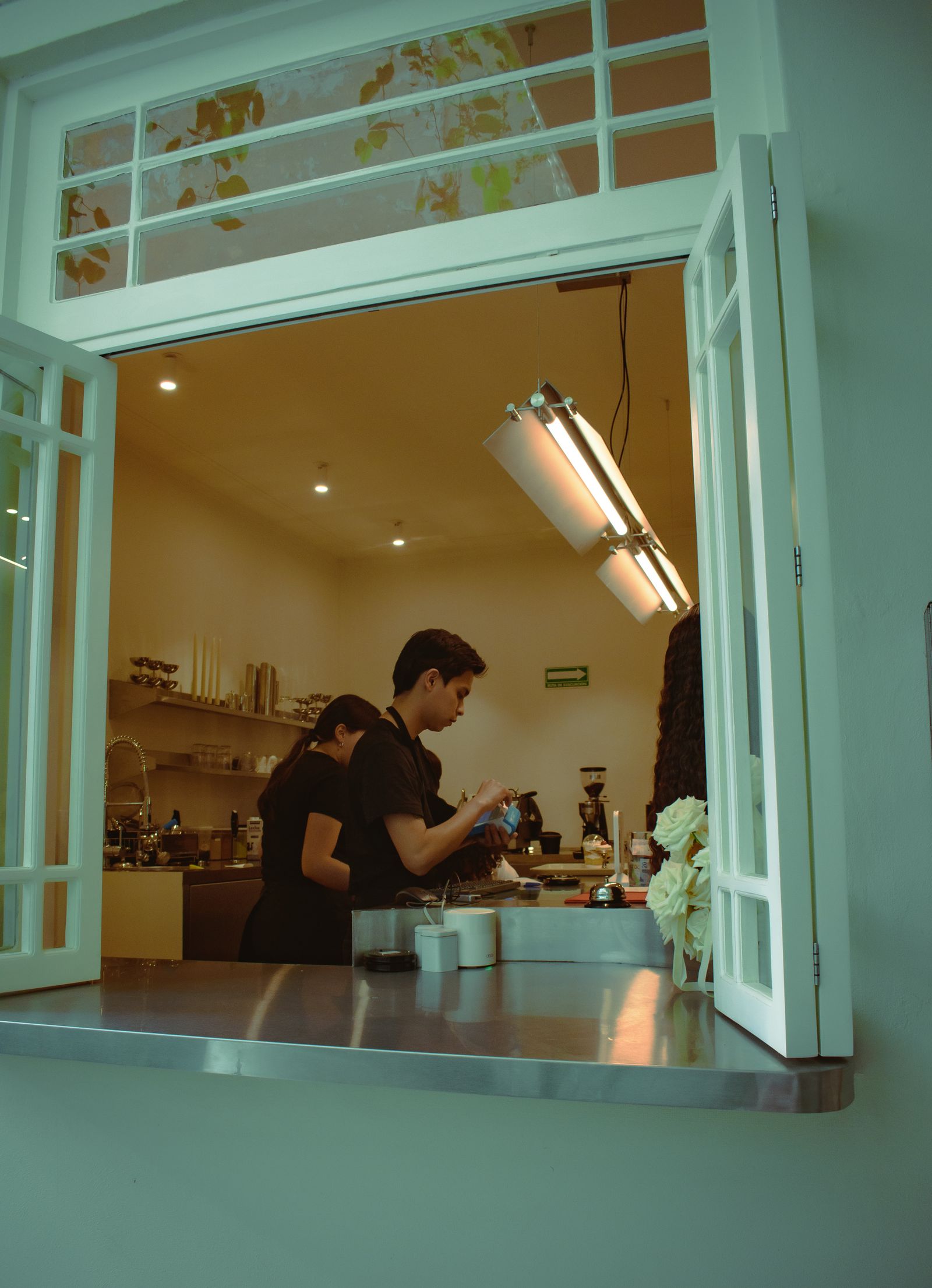 Two cafe workers collaborating in a kitchen