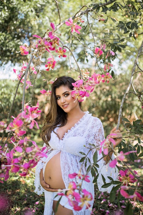 Photo of Pregnant Woman Near Flowers