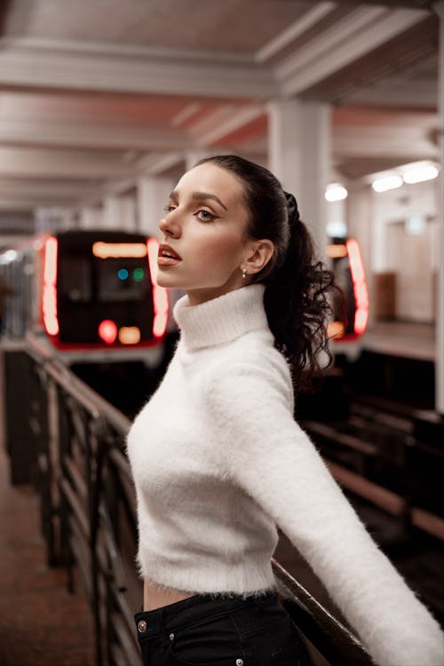 Portrait of Woman in White Sweater at Subway