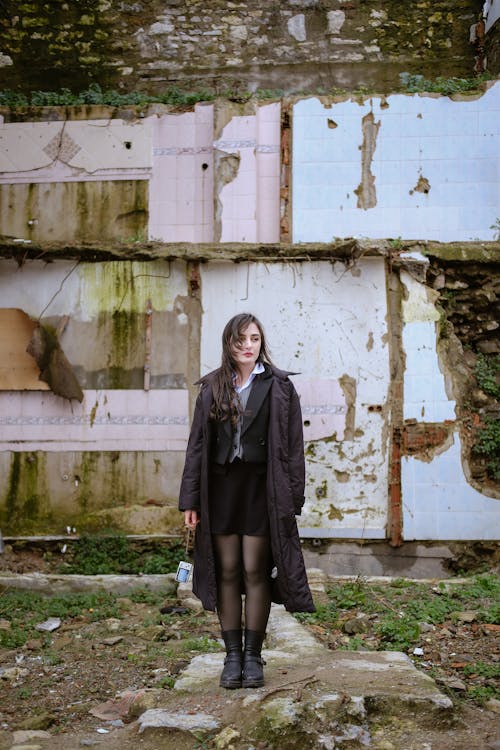 Pretty Brunette Woman in Coat Standing in Abandoned Place