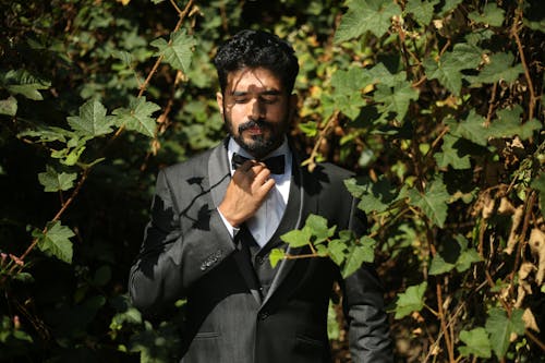 Handsome Groom in Suit Posing in Vineyard