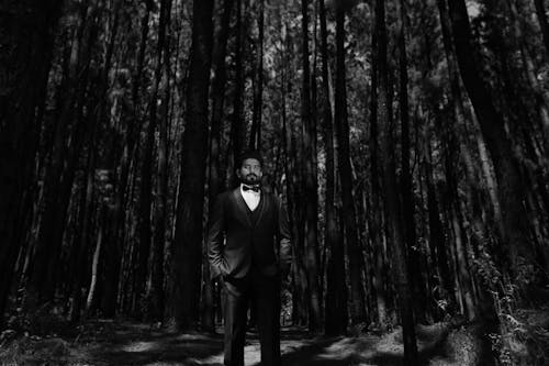 Elegant Groom in Suit Posing in Forest