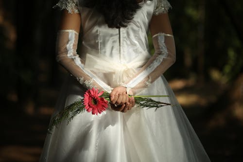 Red Flowers in Hands of Bride