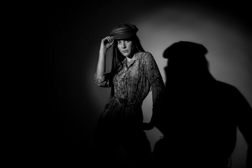 Woman in Cap and Dress in Black and White