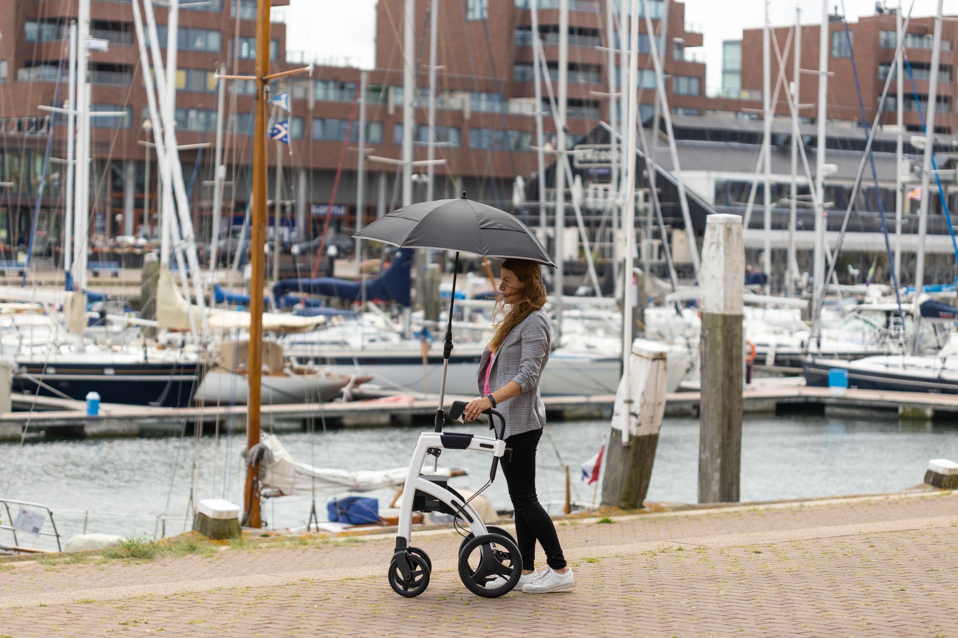 Woman standing with a rollator walker at a dock