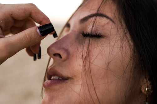 Free Close-up portrait of a young woman with eyes closed, showcasing natural beauty and tranquility. Stock Photo