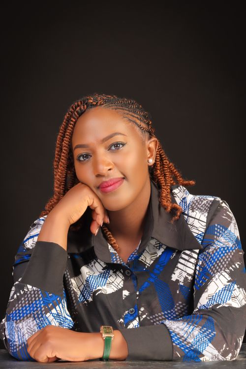 Free A stylish portrait of a confident woman with braided hair against a dark background. Stock Photo