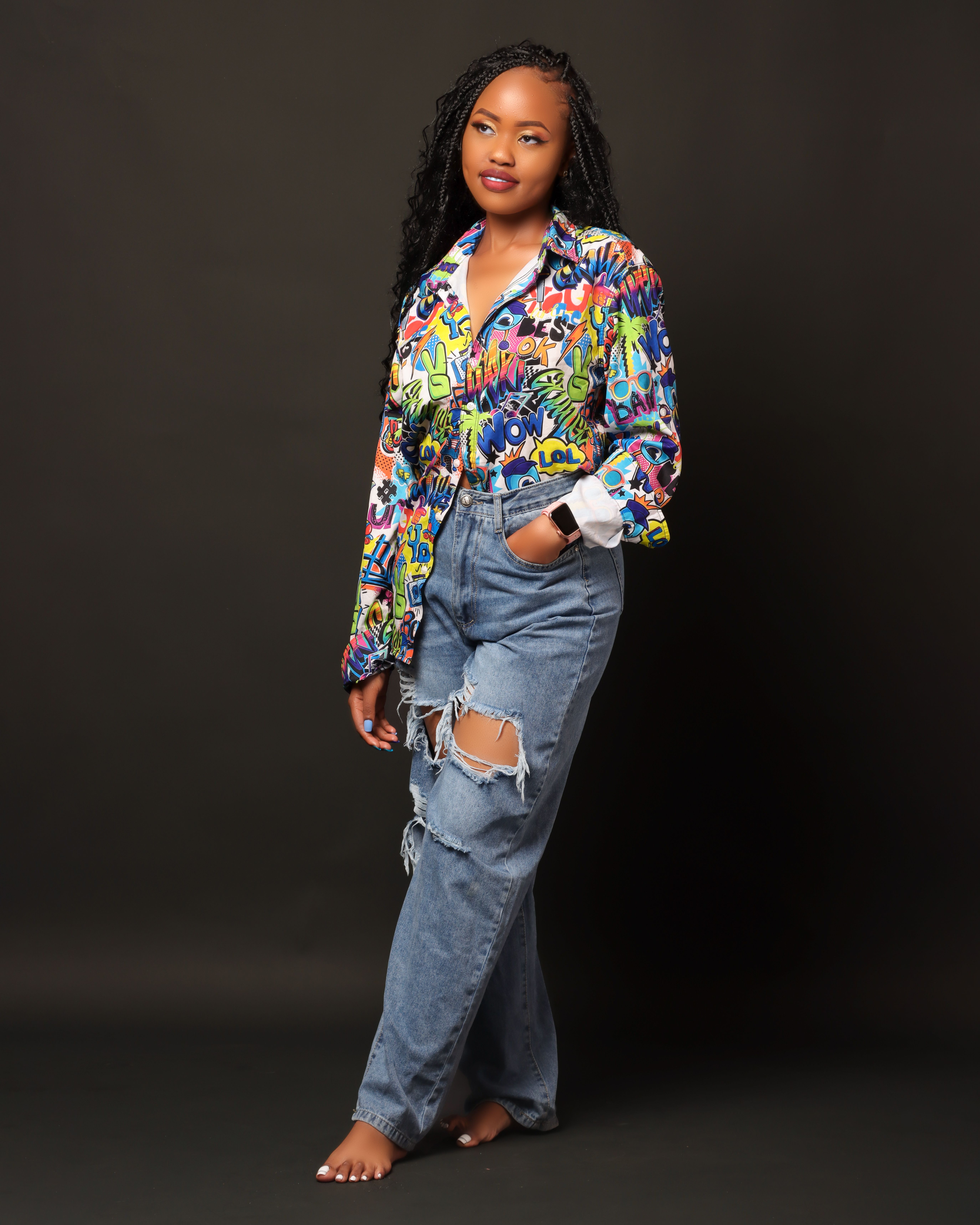 Woman Standing in Torn Jeans and Colorful Shirt · Free Stock Photo