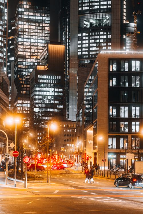 Free Illuminated skyscrapers and busy streets create a bustling cityscape in this vibrant nighttime photo. Stock Photo