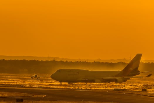 A freight aircraft on the runway at sunset, perfect for travel and aviation themes.