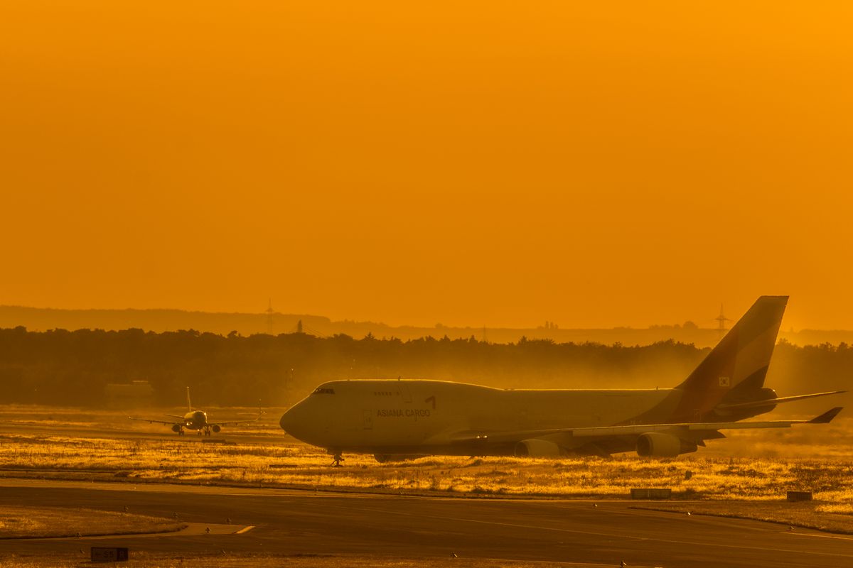 Freighter aircraft on the tarmac at sunset