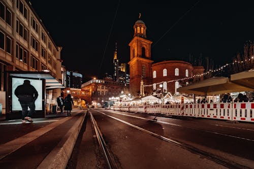 A city street at night with a clock tower