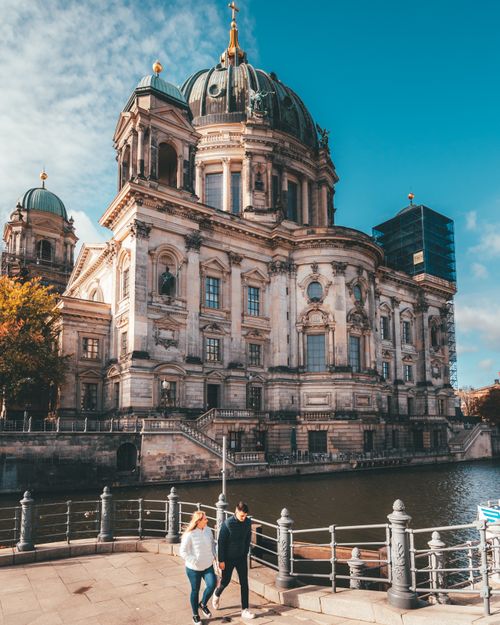Free Berlin Cathedral's stunning architecture bathed in summer sunlight along the river. Stock Photo