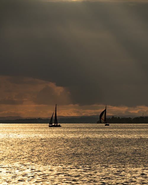 Sailboats under Rain Cloud at Sunset