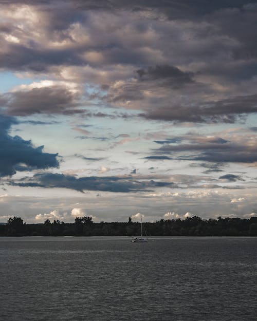 Cloud over Sailboat on Lake