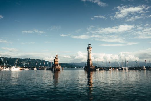 Beautiful landscape of Lindau Harbor featuring the iconic lighthouse and lion statue at Lake Constance.