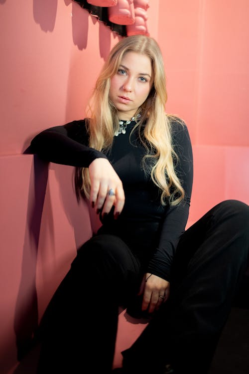 Blonde Woman Sitting in Black Clothes