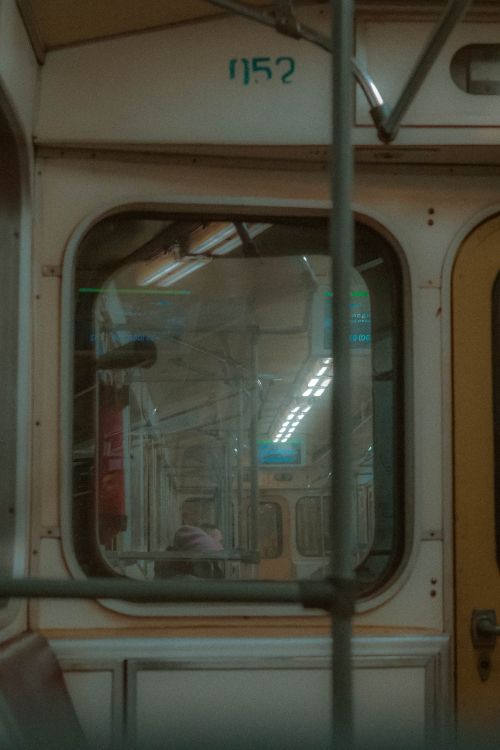 Free Moody view of a vintage subway train interior with reflections in the windows. Stock Photo