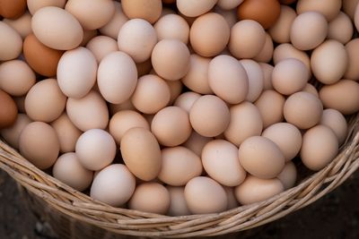 Brown and white eggs in a wicker basket — photo by Engin Akyurt on Pexels