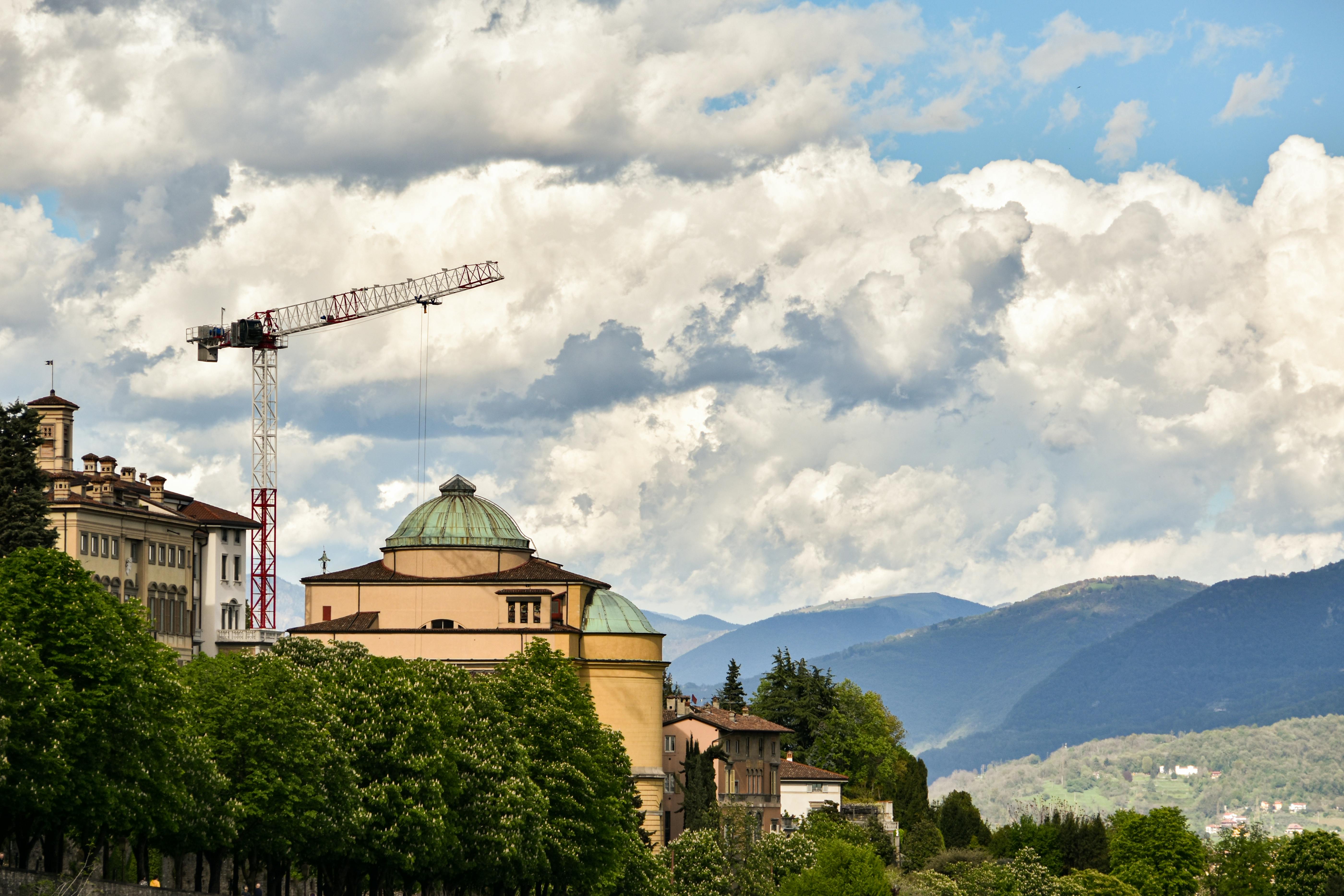Cloud and Construction Crane over Buildings in Town