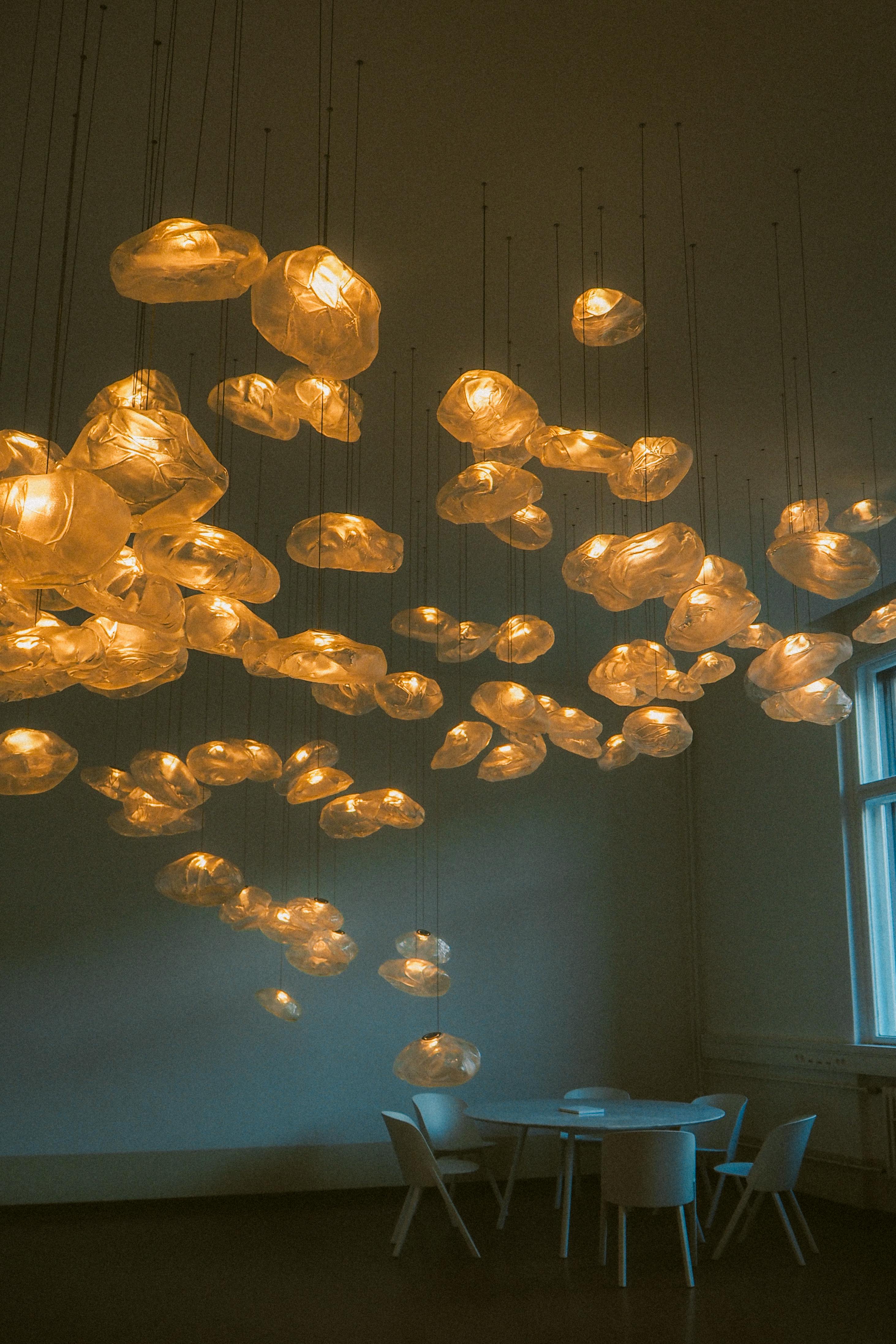 Stylish room with artistic hanging lights and minimalistic furniture design.