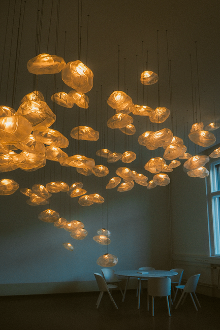 Stylish room with artistic hanging lights and minimalistic furniture design.
