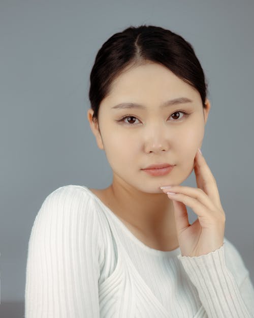 Portrait of a Brunette Wearing a White Sweater